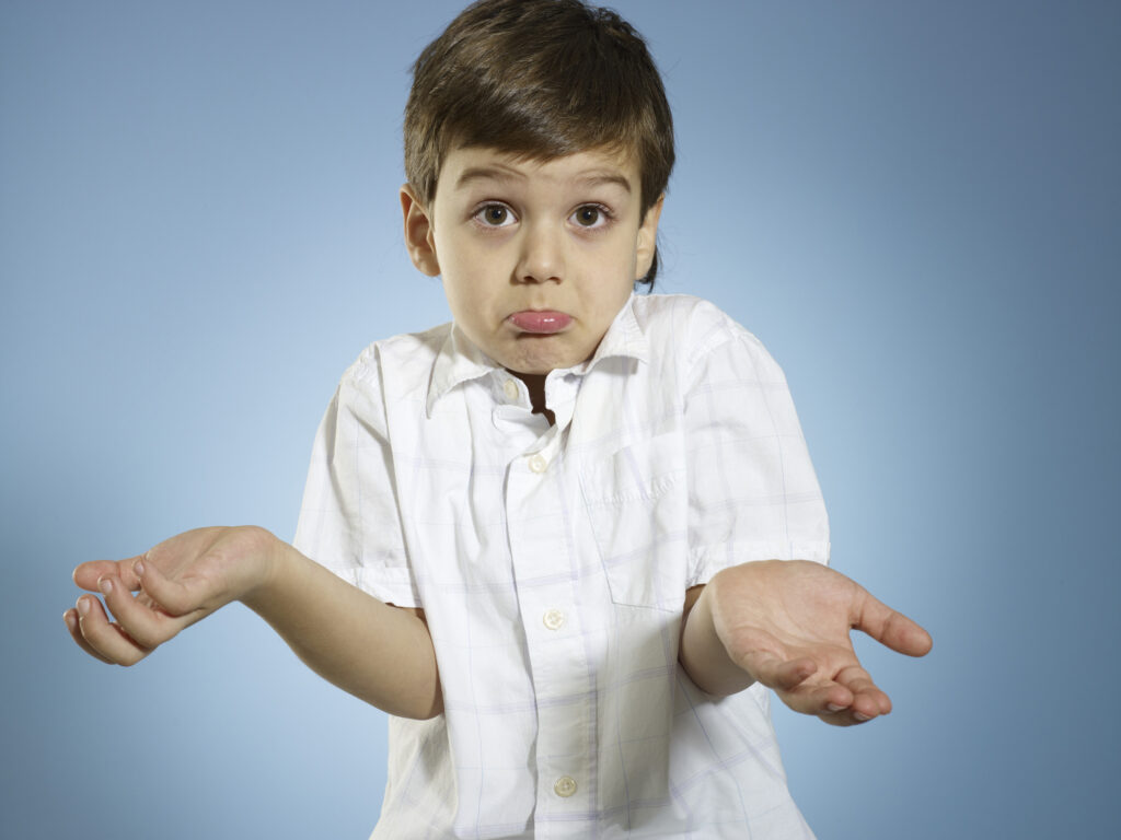 little boy shrugging shoulders