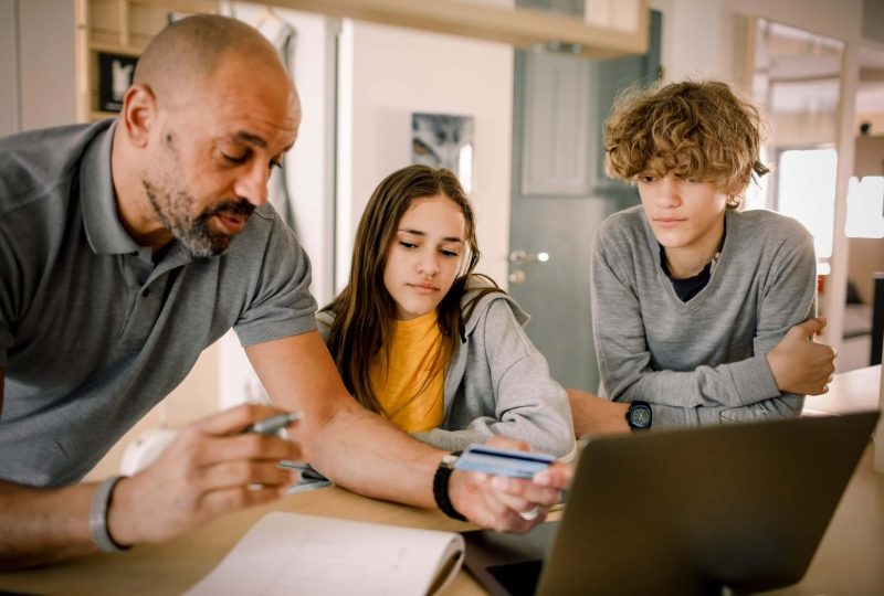 father teaching his daughter and son about shopping online safely